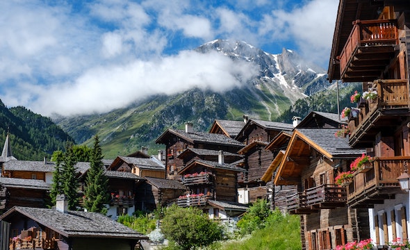 A beautiful Swiss chalet surrounded by trees and mountains